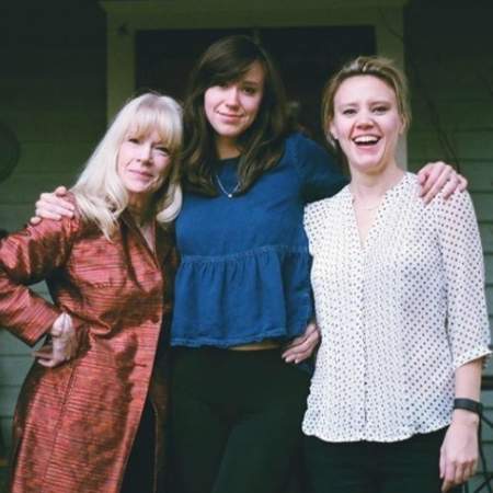 Emily Lynne Berthold (blue dress) along with her sister, Kate McKinnon (right), and mother, Laura Campbell (left).
